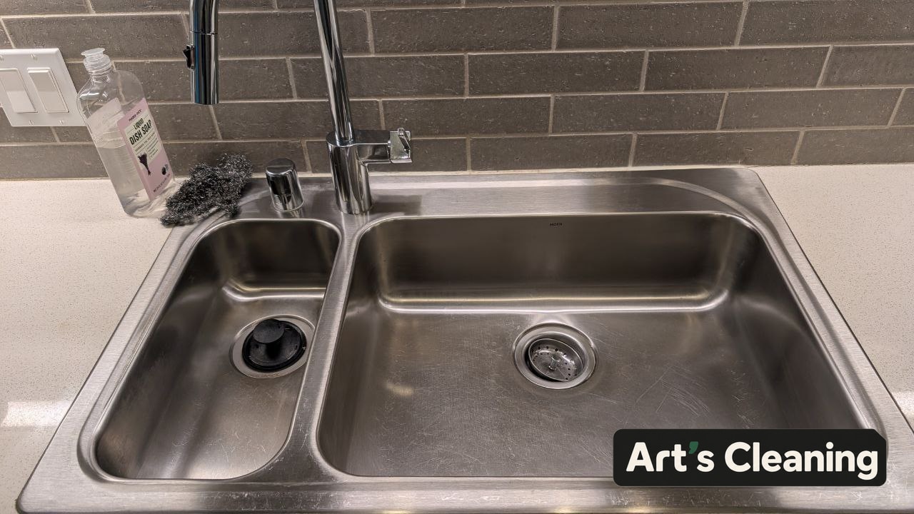 Clean kitchen with a polished double sink and clear counters