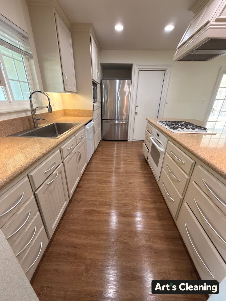 Clean galley kitchen with clear work surfaces
