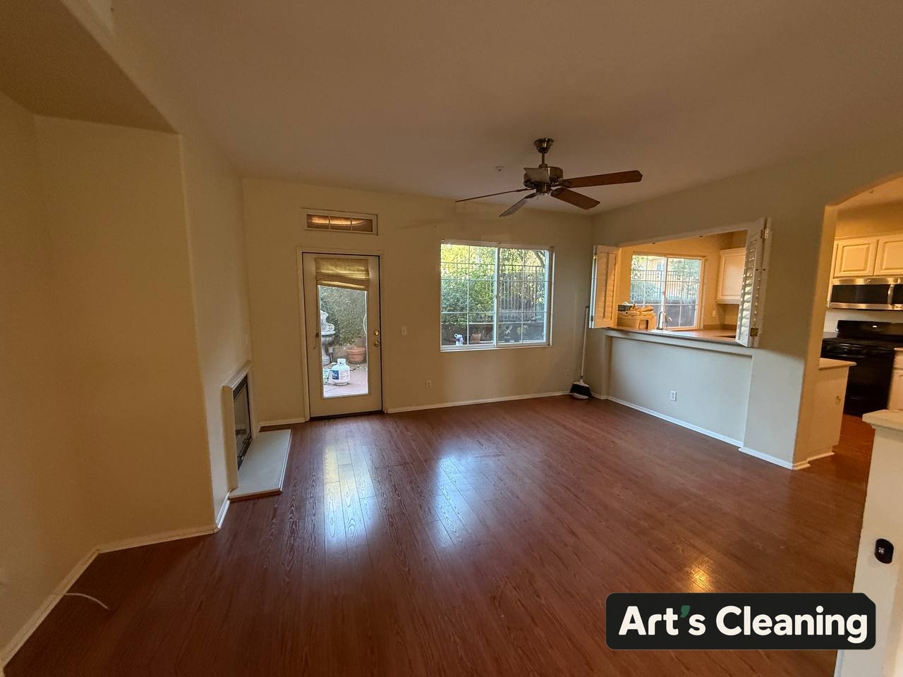 Clean empty living area beside a kitchen