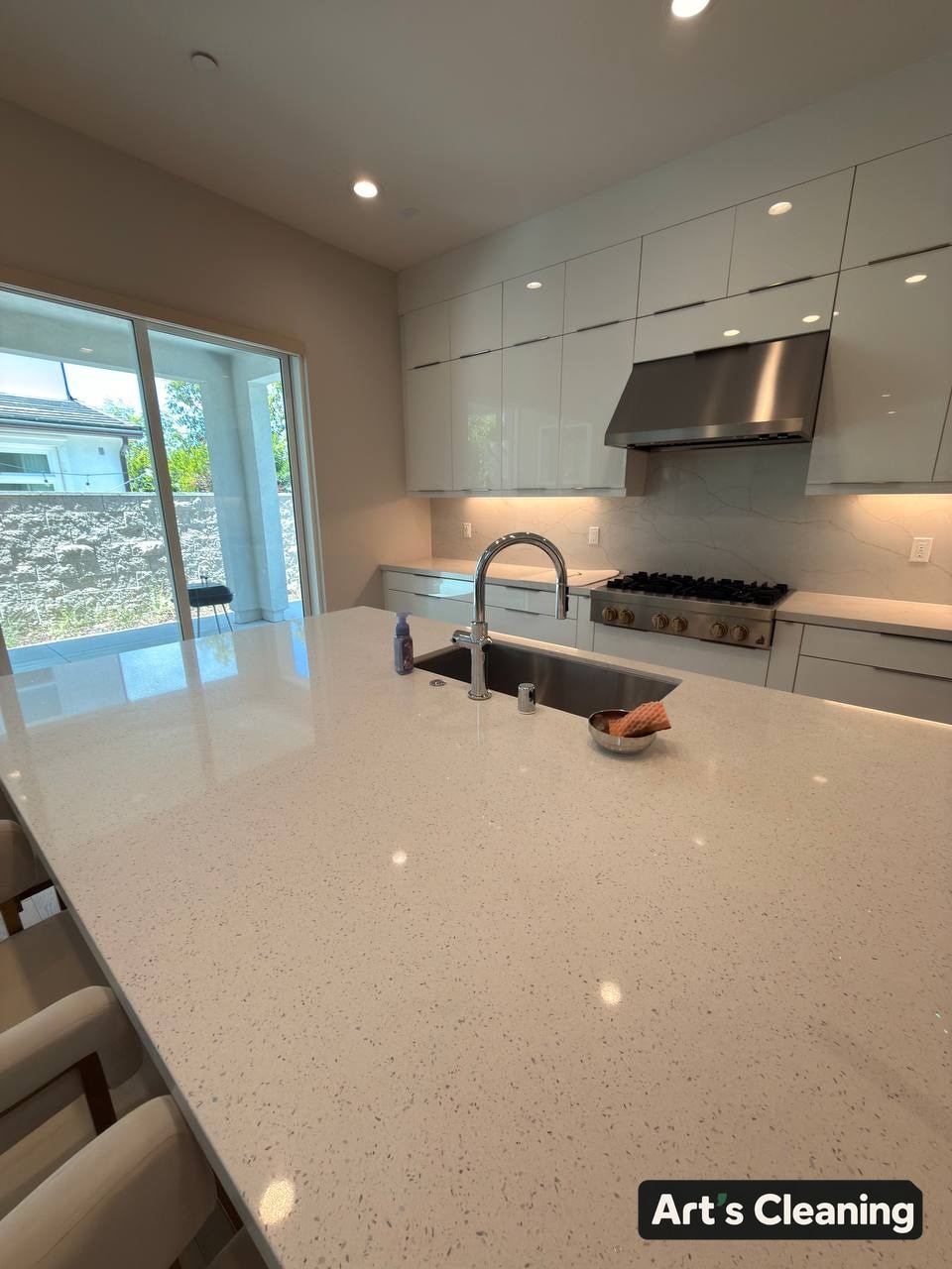 Clean quartz kitchen island and cabinetry